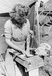 Army nurse does personal washing in her steel helmet, Oujda, Morocco.